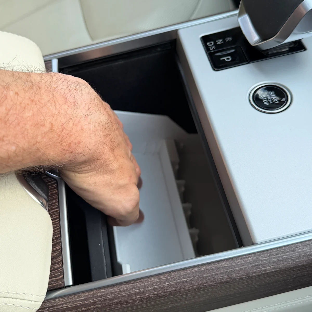 Pushing the Range Rover Hidden Storage Organizer into place