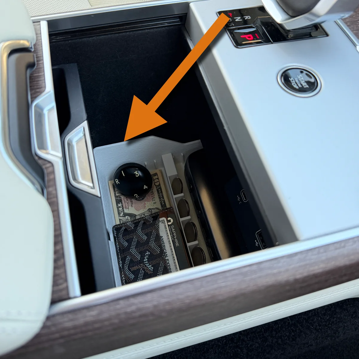 Range Rover Hidden Storage Organizer filled below its bright white side edge